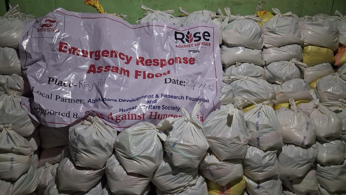 Emergency relief supplies stacked in a warehouse, prepared for distribution to flood-affected communities