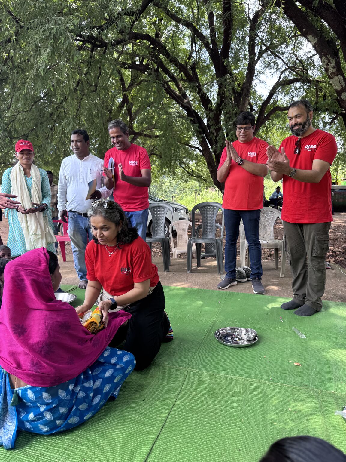 RAHI team distributing food and essentials to a community member during the field visit