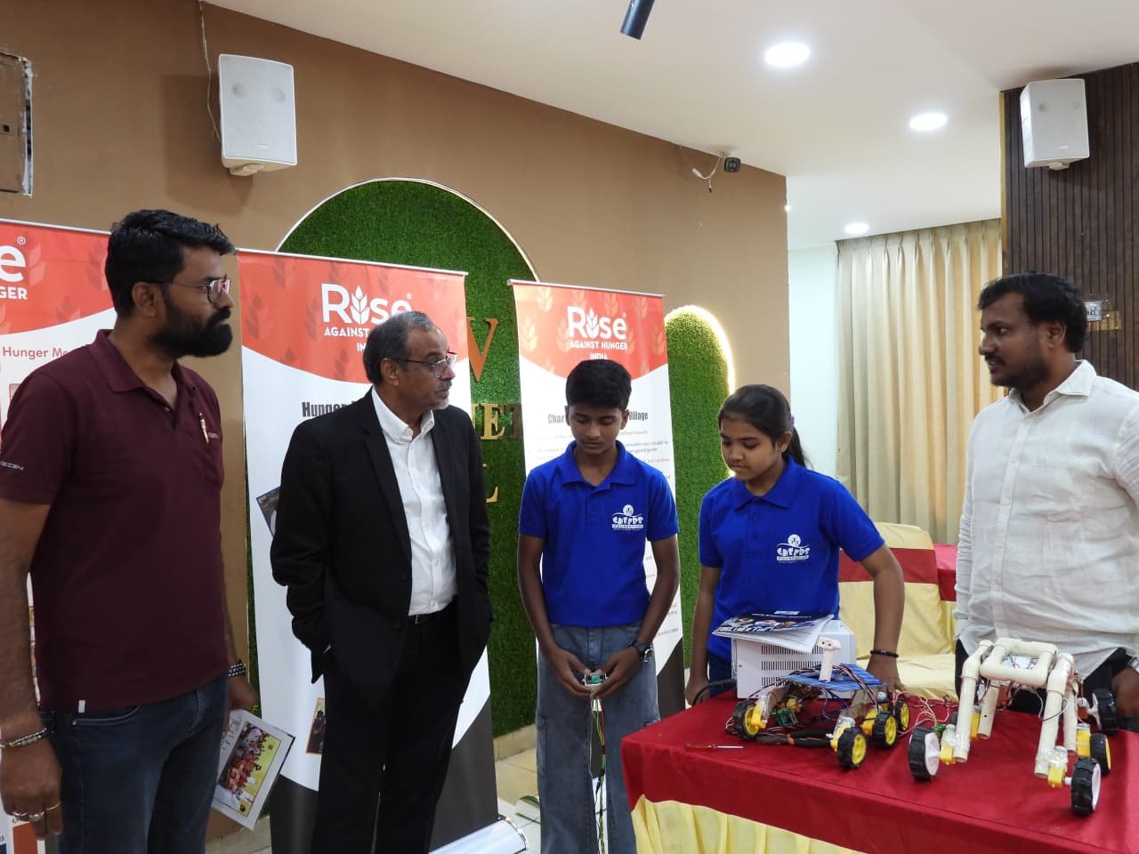 Students presenting their award-winning rover model to Rise Against Hunger India leadership at the Hyderabad inauguration