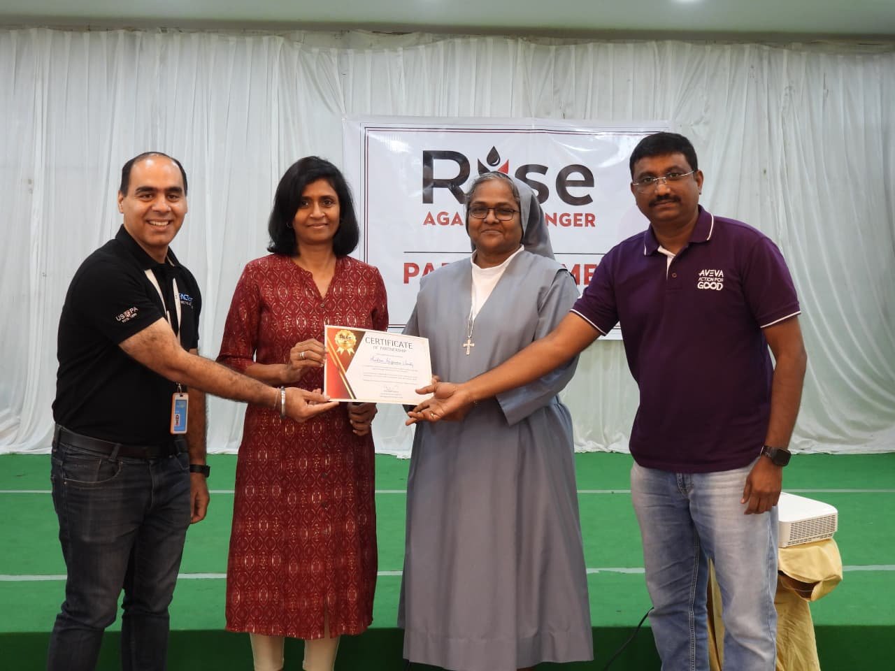 Partner organization receiving a Certificate of Partnership at the Rise Against Hunger India Hyderabad Partners Meet