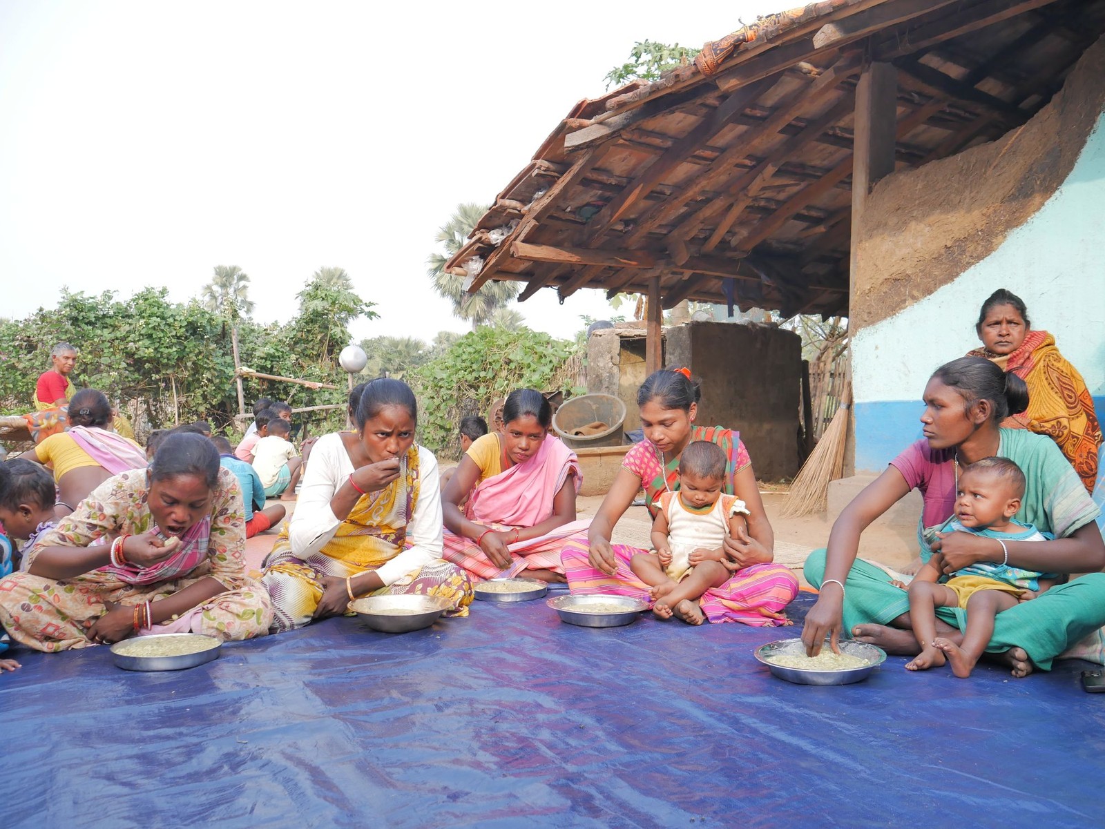 Mothers and children receiving hot-cooked meals at a Rise Against Hunger India Community Kitchen Centre