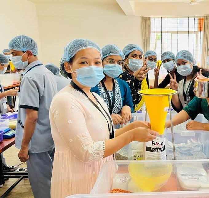 Volunteers packaging meals at a Rise Against Hunger India event